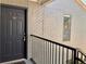 Exterior shot of a condo door in a brick building with stairs and black railing at 3772 Idlebrook Cir # 210, Casselberry, FL 32707