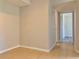 Neutral-toned hallway featuring tiled floors, leading to other rooms with tiled and laminate floors at 3772 Idlebrook Cir # 210, Casselberry, FL 32707