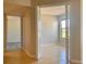 Hallway with tiled floors leading to a bedroom with wood-look floors at 3772 Idlebrook Cir # 210, Casselberry, FL 32707