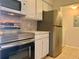 Well-equipped kitchen with stainless steel appliances and white cabinets, practical and stylish at 3772 Idlebrook Cir # 210, Casselberry, FL 32707