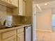 Kitchen area showcasing tiled flooring and classic white cabinets, adjacent to a dining area at 3772 Idlebrook Cir # 210, Casselberry, FL 32707