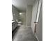 Bathroom featuring shower, gray tile floors, vanity with drawers and gray cabinets at 413 Summit Ridge Pl # 115, Longwood, FL 32779