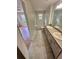 Well-lit bathroom featuring double sinks and a shower and tub combo at 413 Summit Ridge Pl # 115, Longwood, FL 32779