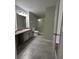 Bathroom featuring shower, gray tile floors, vanity with drawers and gray cabinets at 413 Summit Ridge Pl # 115, Longwood, FL 32779