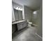 Bathroom featuring shower, gray tile floors, vanity with drawers and gray cabinets at 413 Summit Ridge Pl # 115, Longwood, FL 32779