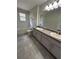 Updated bathroom featuring a bathtub and shower combo, tile floors and vanity with double sinks at 413 Summit Ridge Pl # 115, Longwood, FL 32779
