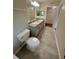Bright bathroom with double sinks, large mirror, and easy access to closet at 413 Summit Ridge Pl # 115, Longwood, FL 32779
