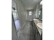 Bathroom featuring a double sink vanity with granite countertops, and a tiled tub and shower combination at 413 Summit Ridge Pl # 115, Longwood, FL 32779