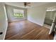 Large bedroom featuring wood flooring, a ceiling fan, and view to bathroom at 413 Summit Ridge Pl # 115, Longwood, FL 32779
