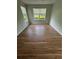 Bright bedroom with hardwood floors, and natural light from large windows with views at 413 Summit Ridge Pl # 115, Longwood, FL 32779
