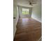 Spacious bedroom with hardwood floors, ceiling fan and natural light from several windows at 413 Summit Ridge Pl # 115, Longwood, FL 32779