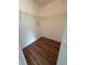 Walk-in closet featuring hardwood floors and plenty of storage at 413 Summit Ridge Pl # 115, Longwood, FL 32779