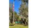 Community sign and American flag, creating an inviting entrance with mature landscaping at 413 Summit Ridge Pl # 115, Longwood, FL 32779