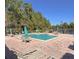 Relaxing community pool area with lounge chairs, tables, umbrellas, and a view of the lake at 413 Summit Ridge Pl # 115, Longwood, FL 32779