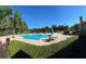 Inviting community pool overlooking a serene lake with comfortable lounge seating at 413 Summit Ridge Pl # 115, Longwood, FL 32779