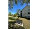 Scenic exterior view with manicured lawn, bench, and pond, perfect for relaxing outdoors at 413 Summit Ridge Pl # 115, Longwood, FL 32779