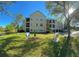 Three story condo building with attached garages and a scenic view of pond at 413 Summit Ridge Pl # 115, Longwood, FL 32779