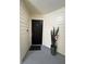 Apartment 115's front door with decorative potted plant and flooring at 413 Summit Ridge Pl # 115, Longwood, FL 32779