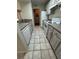 Efficient kitchen with white appliances and cabinets, maximized for space in the condo at 413 Summit Ridge Pl # 115, Longwood, FL 32779