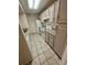 Updated kitchen with white appliances, light-colored cabinets, and modern flooring at 413 Summit Ridge Pl # 115, Longwood, FL 32779