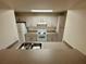 Bright kitchen featuring white appliances, plenty of cabinet space, and a large sink at 413 Summit Ridge Pl # 115, Longwood, FL 32779