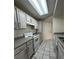 Condo kitchen with updated white cabinets and appliances, offering a functional space at 413 Summit Ridge Pl # 115, Longwood, FL 32779