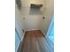 Bright laundry area with hardwood floors and a wire rack for storage at 413 Summit Ridge Pl # 115, Longwood, FL 32779