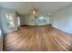 Open living room area with light walls, ceiling fan, and hard wood flooring at 413 Summit Ridge Pl # 115, Longwood, FL 32779