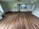 Bright living room with new floors, open layout, and a partial view of the kitchen area at 413 Summit Ridge Pl # 115, Longwood, FL 32779