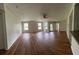 Expansive living room boasts generous natural light, wood-look floors, and an inviting open space at 413 Summit Ridge Pl # 115, Longwood, FL 32779