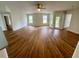Open living room area with light walls and beautiful hard wood flooring at 413 Summit Ridge Pl # 115, Longwood, FL 32779