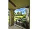 Screened-in patio featuring a ceiling fan and views of the landscaped yard and pond at 413 Summit Ridge Pl # 115, Longwood, FL 32779