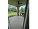Screened-in patio featuring a ceiling fan and views of the landscaped yard and pond at 413 Summit Ridge Pl # 115, Longwood, FL 32779