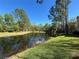 Picturesque pond featuring a fountain, next to a manicured lawn at 413 Summit Ridge Pl # 115, Longwood, FL 32779