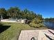 Community pool area with landscaping, brick patio, and lake views at 413 Summit Ridge Pl # 115, Longwood, FL 32779