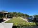 Community pool area with a lake fountain, pergola seating, landscaping, and BBQ at 413 Summit Ridge Pl # 115, Longwood, FL 32779