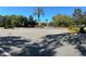 Well-maintained neighborhood entrance with lush landscaping, palm trees, and colorful flowerbeds at 413 Summit Ridge Pl # 115, Longwood, FL 32779