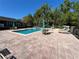 Community swimming pool and patio with lounge chairs, tables and umbrellas at 413 Summit Ridge Pl # 115, Longwood, FL 32779