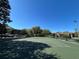 Well-maintained community tennis court surrounded by lush greenery and landscaping at 413 Summit Ridge Pl # 115, Longwood, FL 32779