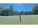 Well-maintained community tennis court surrounded by trees and residential buildings, creating a recreational haven at 413 Summit Ridge Pl # 115, Longwood, FL 32779