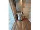 Utility closet featuring water heater, storage shelving, and wood-look flooring at 413 Summit Ridge Pl # 115, Longwood, FL 32779