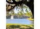 Picturesque lake view featuring a fountain and lovely homes framed by Spanish moss-draped trees at 413 Summit Ridge Pl # 115, Longwood, FL 32779
