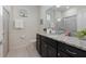 Cozy bathroom featuring granite countertop, and black cabinet with modern fixtures and lighting at 4321 Lana Avenue, Davenport, FL 33897