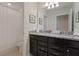 Bathroom featuring dual sink vanity with granite countertop and shower with white curtain at 4321 Lana Avenue, Davenport, FL 33897