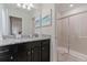 Well-lit bathroom with granite countertop vanity and glass-enclosed shower at 4321 Lana Avenue, Davenport, FL 33897