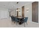 Elegant dining room features a large wooden table with seating for six and a modern light fixture overhead at 4321 Lana Avenue, Davenport, FL 33897