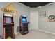 Spacious game room featuring two arcade games, black drop ceiling, and neutral carpet at 4321 Lana Avenue, Davenport, FL 33897