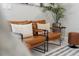 A pair of contemporary chairs with pillows flank a leafy plant in this brightly lit living room at 4321 Lana Avenue, Davenport, FL 33897