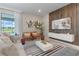 Bright living room with large windows, a decorative wood accent wall, and stylish furniture arrangement at 4321 Lana Avenue, Davenport, FL 33897