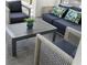 Close-up of the patio's modern seating with patterned pillows and accent plants at 4321 Lana Avenue, Davenport, FL 33897